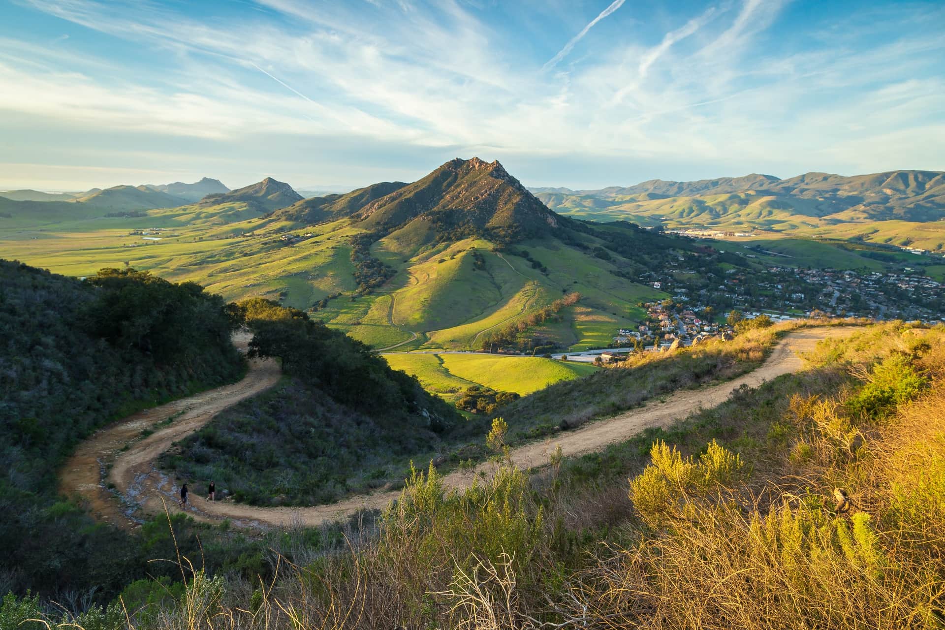 Trail above San Luis Obispo at golden hour, with Bishop Peak and green hills beyond